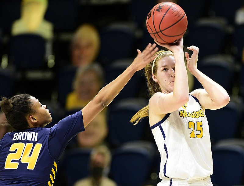 Staff photo by Robin Rudd / UTC's Abbey Cornelius (25) shoots as UNC Greensboro's Jaylynn Brown defends during a SoCon basketball game Feb. 19 at McKenzie Arena. Cornelius said having made it through the regular season despite the COVID-19 pandemic should be considered "a big accomplishment" for the team.