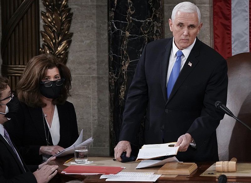 Photo by J. Scott Applewhite of The Associated Press / In this Jan. 6, 2021, photo, Senate Parliamentarian Elizabeth MacDonough, second from left, works beside Vice President Mike Pence during the certification of Electoral College ballots in the presidential election, in the House chamber at the Capitol in Washington.