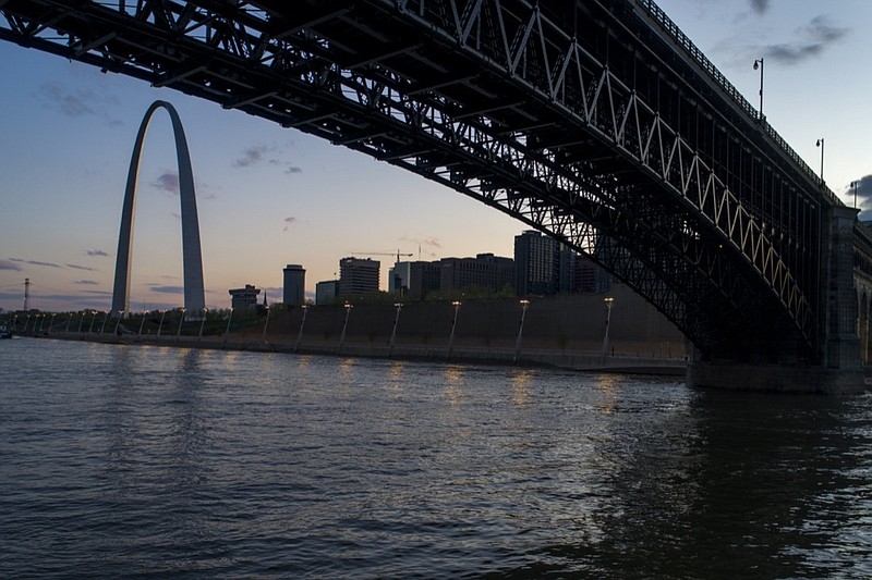 FILE - The Eads Bridge crosses the Mississippi River from Illinois to Missouri as the sun sets beyond the Gateway Arch, Tuesday, April 14, 2020, in St. Louis. Cities along the Mississippi River will take part in a global system to determine where plastic pollution comes from and how it ends up in waterways as a first step toward solving the problem, officials said Wednesday, March 3, 2021. (AP Photo/Jeff Roberson)