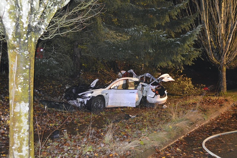 FILE - In this Nov. 17, 2020, file photo provided by the Corvallis Police Department is the scene where an Oregon man crashed a Tesla while going about 100 mph, destroying the vehicle, a power pole and starting a fire when some of the hundreds of batteries from the vehicle broke windows and landed in residences in Corvallis, Ore. Dylan Milota, who survived the crash, was driving the 2019 Tesla S when he lost control. Pandemic lockdowns and stay-at-home orders kept many drivers off U.S. roads and highways in 2020. But those who did venture out found open lanes that only invited reckless driving, leading to a sharp increase in traffic-crash deaths across the country. (Corvallis Police Department via AP, File)