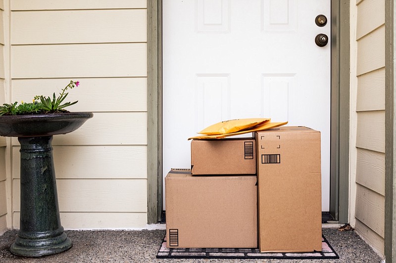 Front Door of House with Stack of Delivery Boxes from Online Ordering and E-commerce package tile packages business shipping porch tile box boxes / Getty Images
