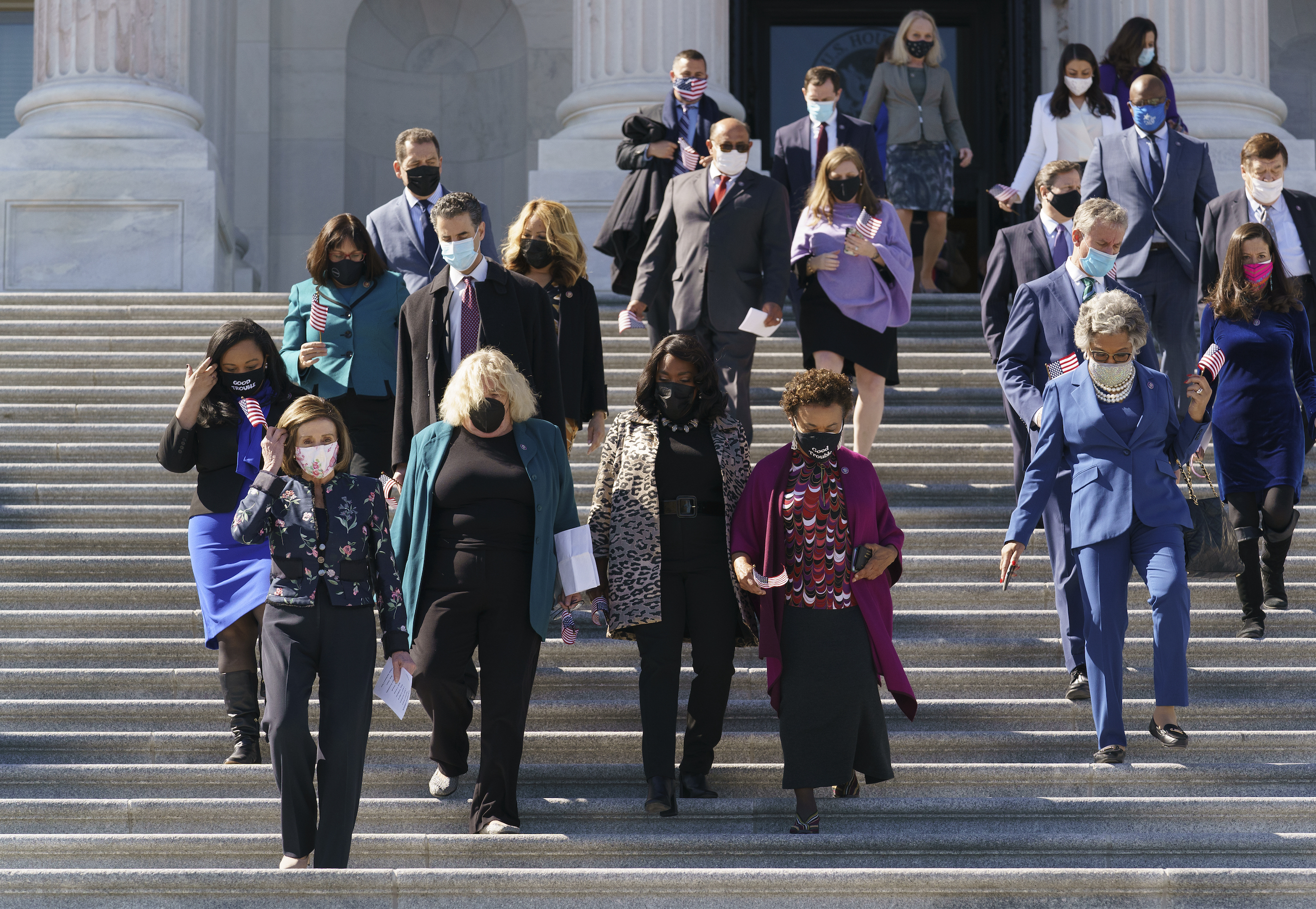 Speaker of the House Nancy Pelosi, D-Calif., lower left, and members of the Democratic Caucus gather to address reporters on H.R. 1, the For the People Act of 2021, at the Capitol in Washington, Wednesday, March 3, 2021. (AP Photo/J. Scott Applewhite)