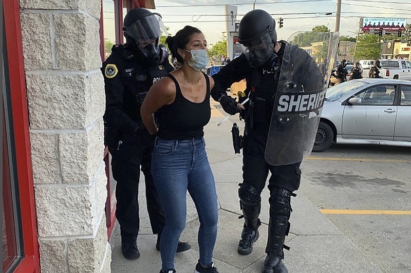 Police officers are shown arresting Des Moines Register reporter Andrea Sahouri after a Black Lives Matter protest she was covering on May 31, 2020, in Des Moines, Iowa, was dispersed by tear gas. (Photo courtesy Katie Akin via AP)


