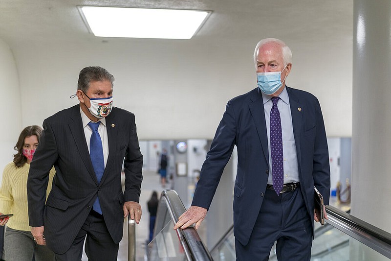 Sen. Joe Manchin, D-W.Va., left, and Sen. John Cornyn, R-Texas, head to the chamber as the Senate steers toward a voting marathon on the Democrats' $1.9 trillion COVID-19 relief bill that's expected to end with the chamber's approval of the measure, at the Capitol in Washington, Friday, March 5, 2021. (AP Photo/J. Scott Applewhite)