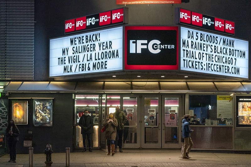 Kathyn Dennet, center, and Brian Haver leave the IFC Center after viewing a screening on "Mank", Friday, March 5, 2021, in New York. The couple who live in the Bronx came to Manhattan to view the movie at their favorite theatre. After growing cobwebs for nearly a year, movie theaters in New York City reopen Friday, returning film titles to Manhattan marquees that had for the last 12 months read messages like "Wear a mask" and "We'll be back soon." Cinemas in the city are currently operating at only 25% capacity, with a maximum of 50 per each auditorium. (AP Photo/Mary Altaffer)


