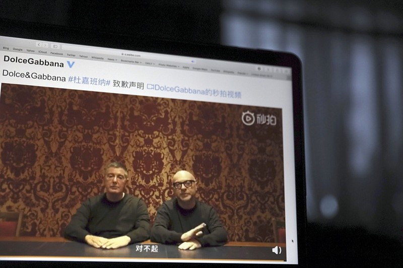 FILE - In this Nov. 23, 2018, file photo, founders of Dolce&Gabbana Domenico Dolce, left and Stefano Gabbana apologize in a video on Chinese social media, saying "sorry" in Mandarin seen on a computer screen in Beijing, China. The Milan fashion house Dolce&Gabbana filed a multi-million-dollar defamation suit in an Italian court against U.S. fashion bloggers who reposted anti-Asian comments attributed to one of the designers that led to a boycott by Asian consumers. The suit was filed in Milan civil court in 2019, but only became public this week, Thursday, March 4, 2021, when the bloggers posted about it on their Instagram profile, Diet Prada. (AP Photo/Ng Han Guan, File)


