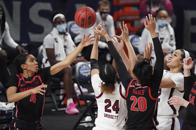 AP photo by Sean Rayford / Georgia's Mikayla Coombs, left, and Jordan Isaacs battle for a rebound with South Carolina's LeLe Grissett (24) and Brea Beal during the second half of the SEC tournament title game Sunday in Greenville, S.C.