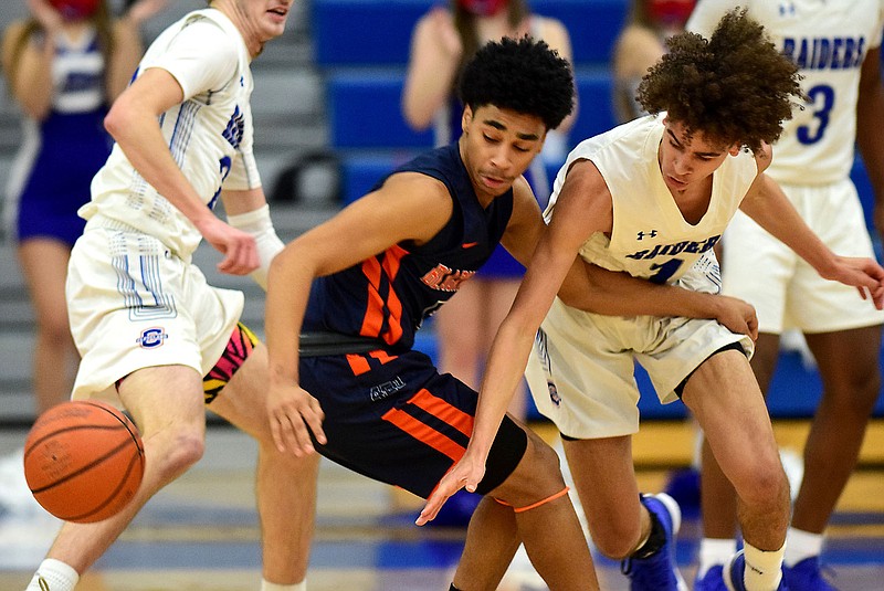 Staff Photo by Robin Rudd / Cleveland's Michael Dale (1) knocks the ball away from a Blackman player.   The Cleveland Blue Raiders hosted the Blackman Blaze in a TSSAA Sectional game on March 8, 2021.  