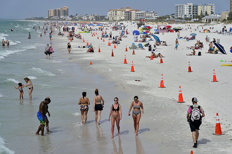 Beachgoers take advantage of the weather as they spend time on Clearwater Beach Tuesday, March 2, 2021, in Clearwater, Fla., a popular spring break destination, west of Tampa. Colleges around the U.S. are scaling back spring break or canceling it entirely to discourage beachfront partying that could raise infection rates back on campus. (AP Photo/Chris O'Meara)