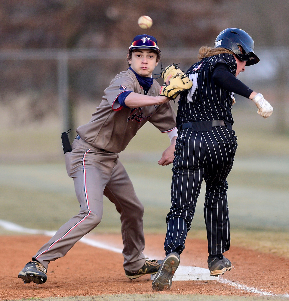 Staff Photo by Robin Rudd / Southeast's Ethan Hill (7) is safe at first after a bunt. Heritage's Gage Shaver 914) moves to the ball. The Heritage Generals hosted the Southeast Whitfield Raiders in GHSA basely on March 9, 2021.