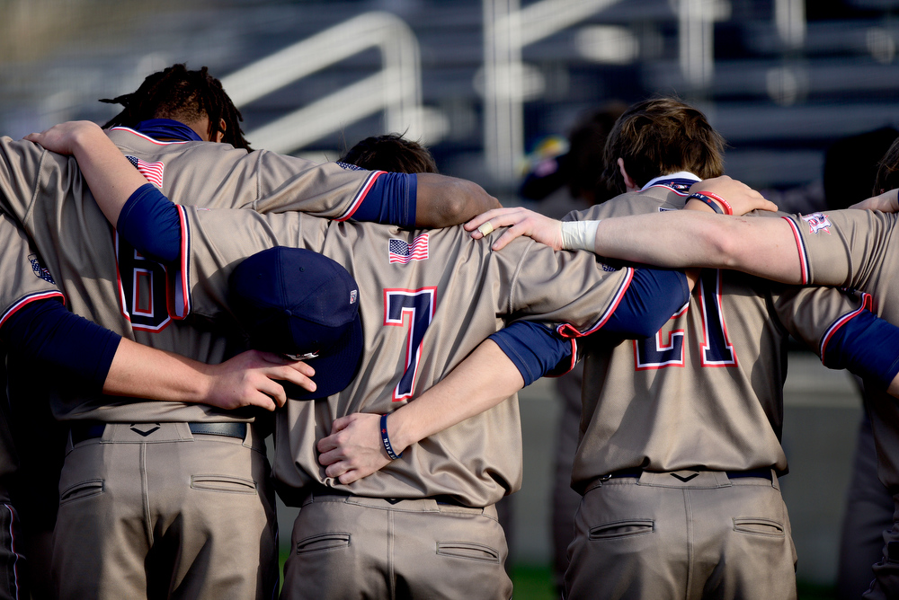 Staff Photo by Robin Rudd / The Generals gather for prayer behind home plate. The Heritage Generals hosted the Southeast Whitfield Raiders in GHSA basely on March 9, 2021.