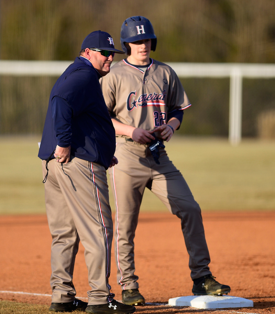Staff Photo by Robin Rudd / Heritage head coach Joseph Beagles confers with Cannon Stafford (22) at thrid base. The Heritage Generals hosted the Southeast Whitfield Raiders in GHSA basely on March 9, 2021.