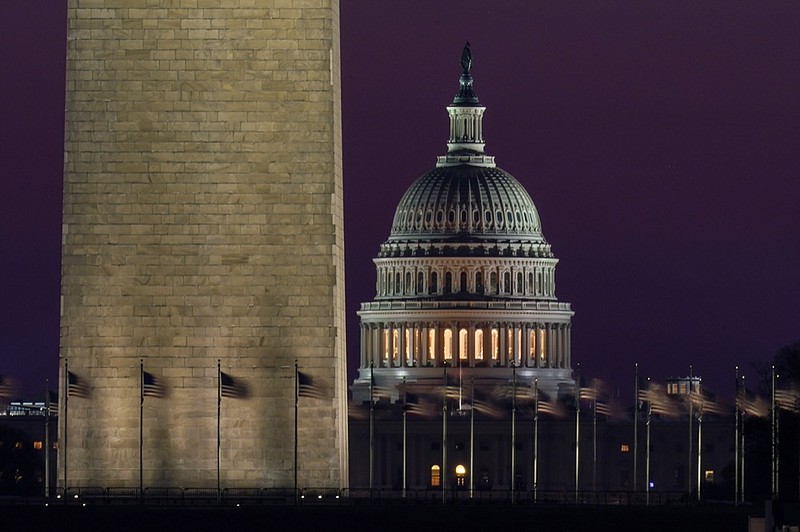 The Capitol is seen beyond the base of the Washington Monument before sunrise in Washington, Wednesday, March 10, 2021. (AP Photo/Carolyn Kaster)


