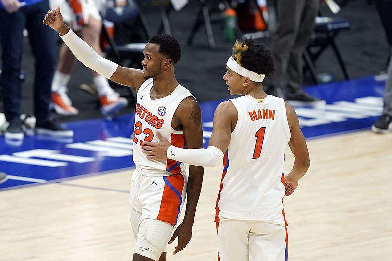 AP photo by Mark Humphrey / Florida's Scottie Lewis and Tre Mann leave the court after the Gators beat Vanderbilt in the second round of the SEC tournament Thursday in Nashville.