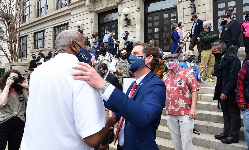 Staff Photo by Matt Hamilton / Chattanooga mayoral candidate Tim Kelly talks with Larry "Bear" High from Bear's Barber Shop after his rally at City Hall on Thursday.