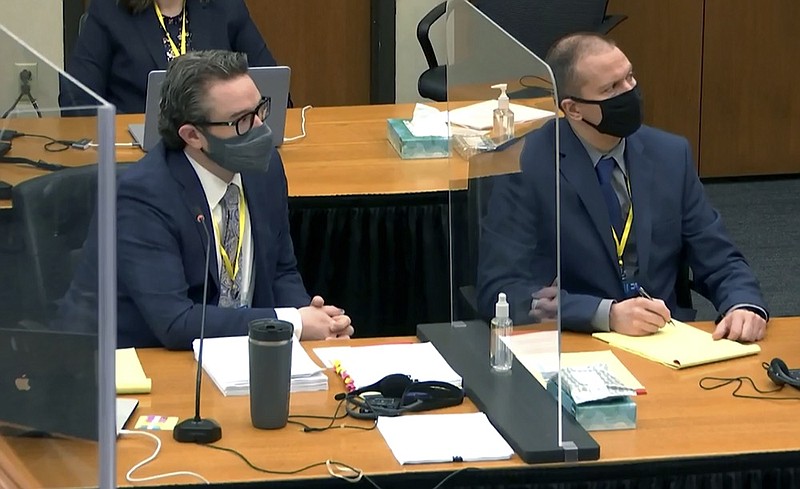 In this image taken from video, defense attorney Eric Nelson, left, and defendant, former Minneapolis police officer Derek Chauvin, right, listen to Hennepin County Judge Peter Cahill during pretrial motions, prior to continuing jury selection in the trial of Chauvin, Thursday, March 11, 2021, at the Hennepin County Courthouse in Minneapolis, Minn. Chauvin is accused in the May 25, 2020, death of George Floyd. (Court TV/Pool via Pool)


