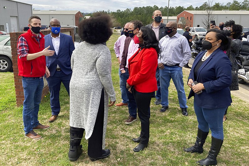 Rep. Terri Sewell, D-Ala, in the center wearing red, and Rep. Nikema Williams, D-Ga., at the far right, join fellow members of Congress, labor organizers and employees at an Amazon facility in Bessemer, Ala., on March 5, 2021. The nearly 6,000 workers at the plant are voting on whether to form a union. The election is the largest unionizing effort ever for Amazon, one of the world's wealthiest firms, and would be a major victory for organized labor and its Democratic Party allies as the labor movement tries to reverse decades of declining membership nationally. (AP Photo/Bill Barrow)