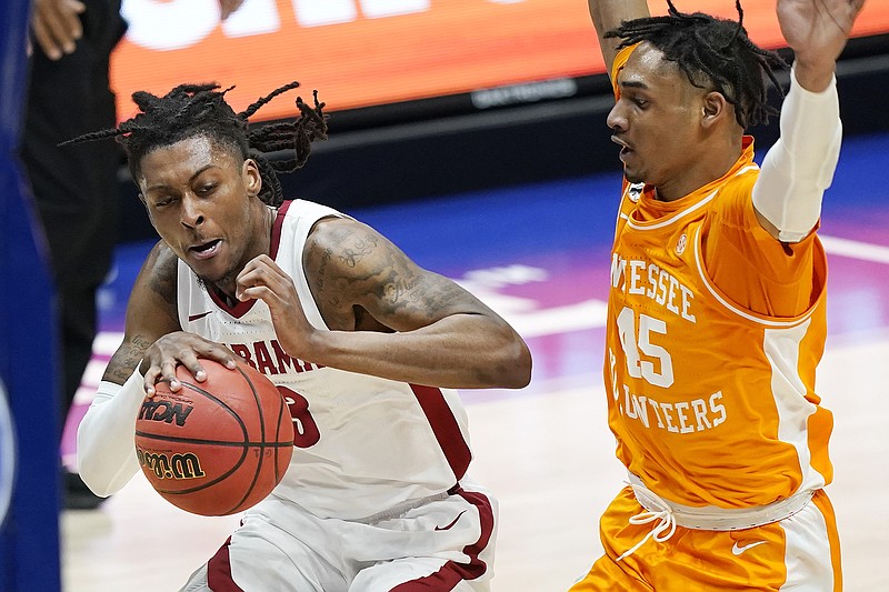 AP photo by Mark Humphrey / Tennessee's Keon Johnson, right, guards Alabama's John Petty Jr. during the first SEC tournament semifinal Saturday at Bridgestone Arena in Nashville. Alabama won 73-68 to advance to Sunday's title game and will face LSU, which beat Arkansas 78-71 in the second semifinal.