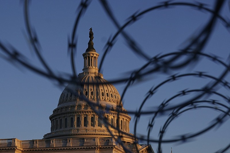 The Capitol is seen through razor wire at sunrise in Washington, Friday, March 5, 2021. (AP Photo/Carolyn Kaster)


