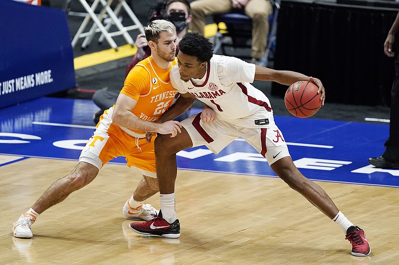 AP photo by Mark Humphrey / Tennessee's Santiago Vescovi, left, guards Alabama's Herbert Jones during an SEC tournament semifinal Saturday in Nashville. Alabama beat the Vols and went on to defeat LSU in the league title game Sunday, but both teams are in the NCAA tournament, with the Crimson Tide a No. 2 seed and Tennessee a No. 5 seed.