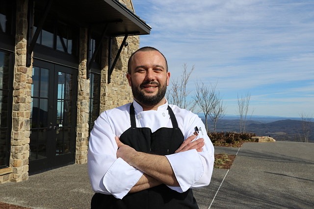 Contributed Photo by Derryberry Public Relations / Anthony Hooper poses in front of The Creag, the McLemore Club golf resort restaurant in Rising Fawn, Ga., where he is executive chef.
