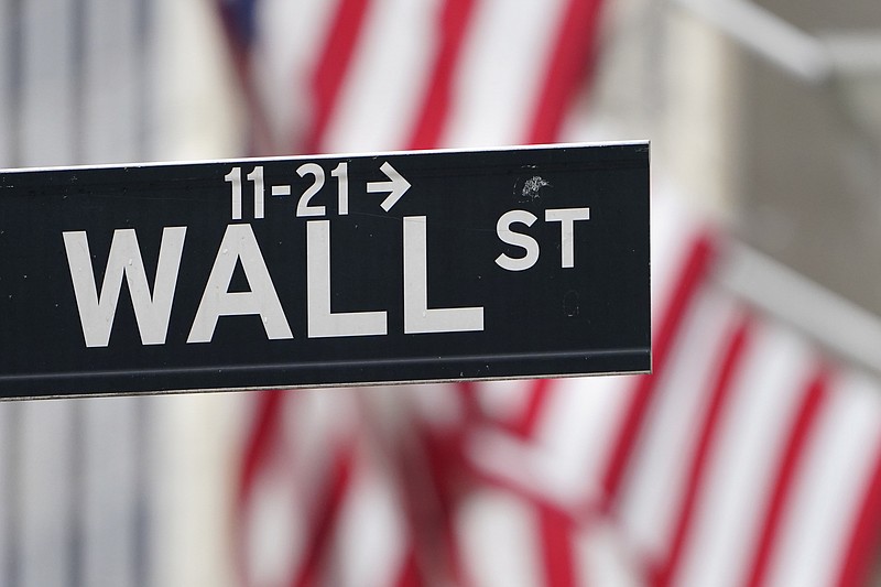 In this Nov. 23, 2020 file photo, a street sign is displayed at the New York Stock Exchange in New York. Stocks were mixed in early trading on Monday, March 15, 2021, as investors sifted a mixed bag of data from China. Wall Street continues to eye the bond market, where yields gave back some of last week's gains. (AP Photo/Seth Wenig, File)