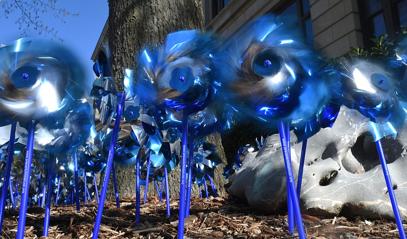 Staff file photo by Angela Lewis Foster / Blue pinwheels spin outside of Chattanooga City Hall on Friday, April 7, 2017, to raise awareness of child abuse. April is child abuse prevention and awareness month.