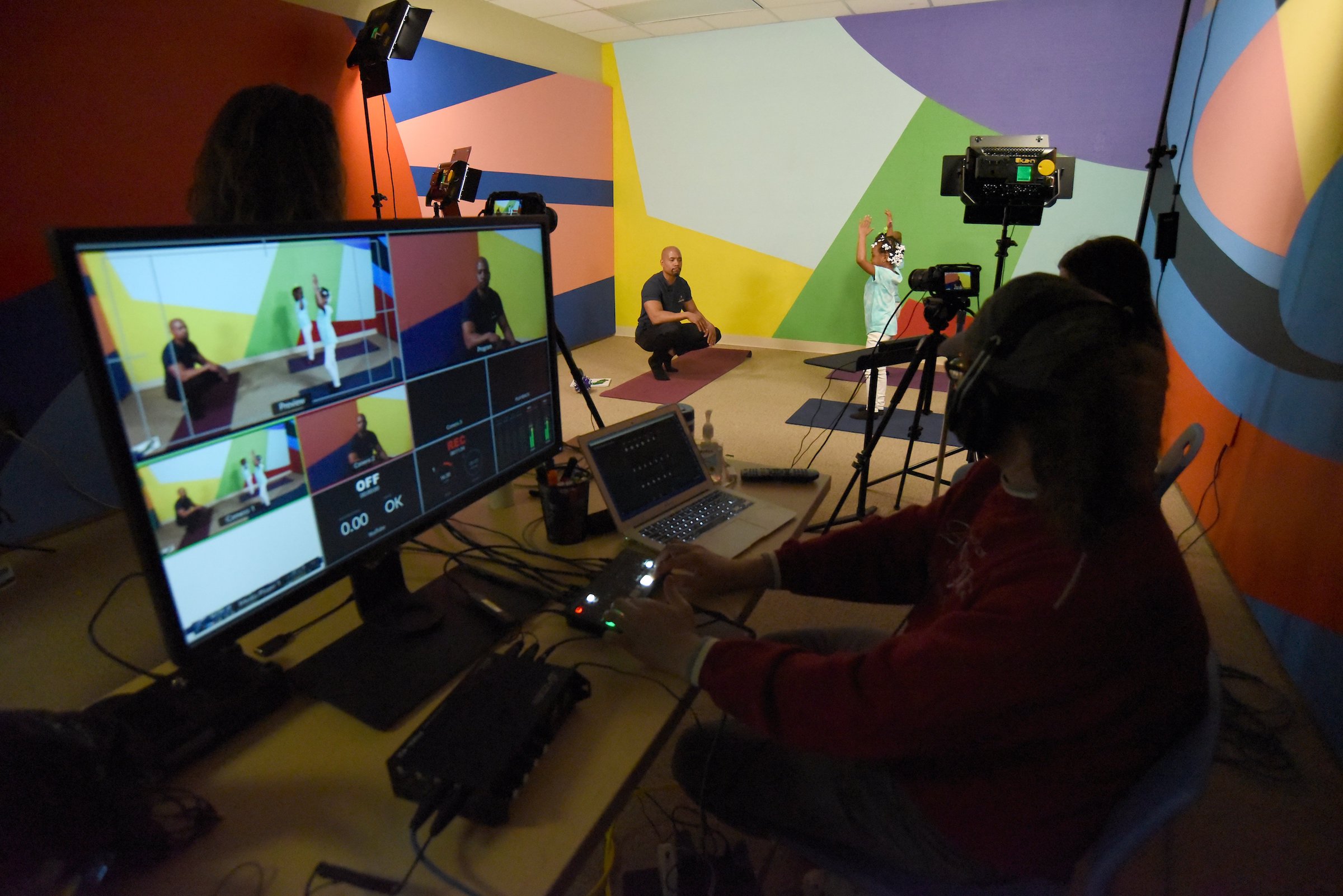 Staff Photo by Matt Hamilton / WTCI Educational Content Producer Corey Knollinger, front, talks with UTC student Johnny Martin while filming an educational lesson about yoga at WTCI in Chattanooga on Wednesday, March 17, 2021.