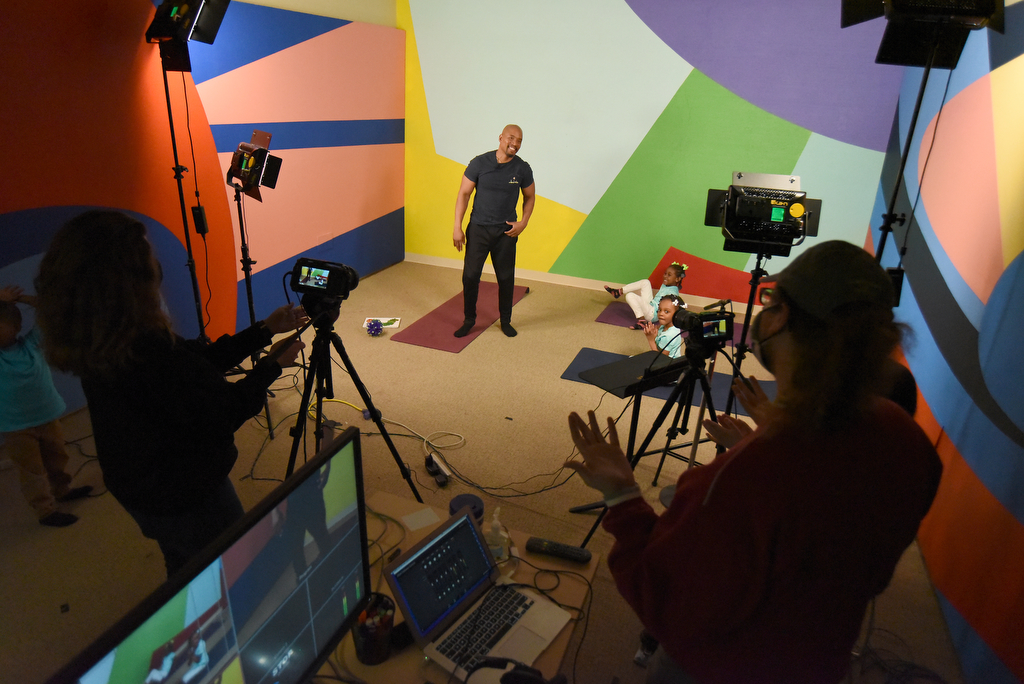 Staff Photo by Matt Hamilton / WTCI Educational Content Producer Corey Knollinger, front, talks with UTC student Johnny Martin while filming an educational lesson about yoga at WTCI in Chattanooga on Wednesday, March 17, 2021.