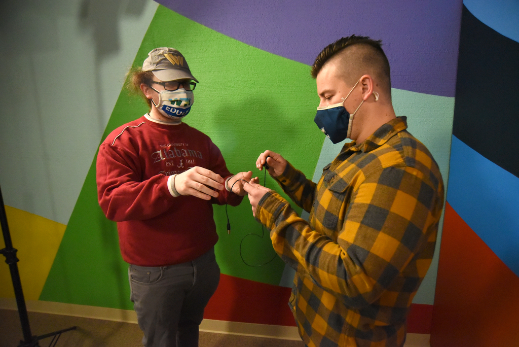 Staff Photo by Matt Hamilton / Educational Content Producer Corey Knollinger, left, talks to UTC student Jonathan McKenzie before recording his educational lesson at WTCI in Chattanooga on Wednesday, March 17, 2021.