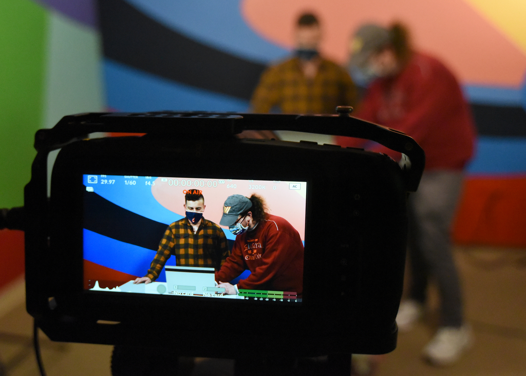 Staff Photo by Matt Hamilton / Educational Content Producer Corey Knollinger, left, talks to UTC student Jonathan McKenzie before recording his educational lesson at WTCI in Chattanooga on Wednesday, March 17, 2021.
