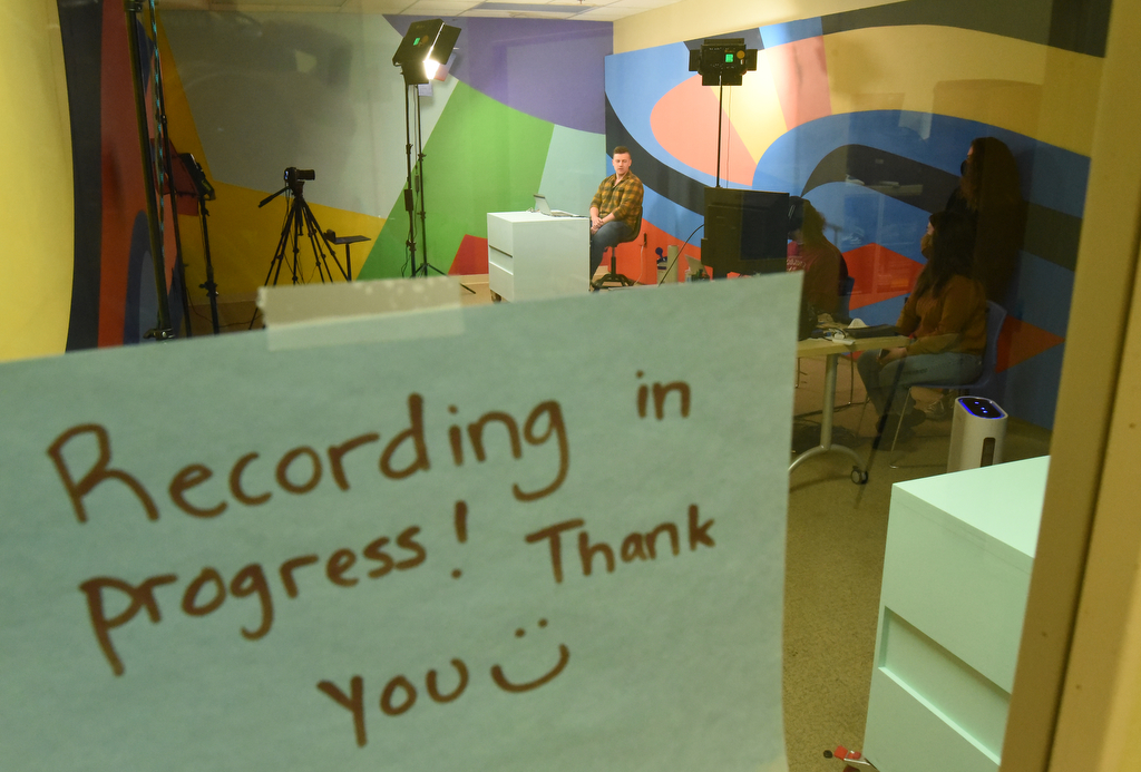 Staff Photo by Matt Hamilton / A sign on the door of the recording studio warns visitors to not interrupt as UTC student Jonathan McKenzie records an educational lesson at WTCI in Chattanooga on Wednesday, March 17, 2021.