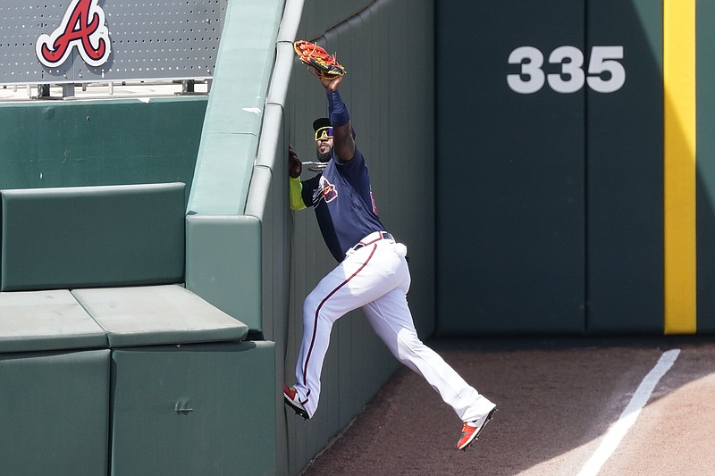 AP photo by John Bazemore / Atlanta Braves left fielder Marcell Ozuna makes a catch in foul territory to retire the Minnesota Twins' Luis Arraez during an exhibition game at spring training on March 5 in North Port, Fla.