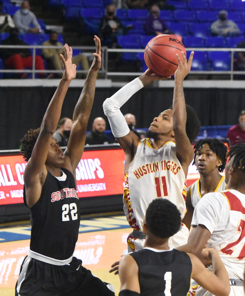 Staff Photo by Matt Hamilton / Howard's (11) Xavier Fisher puts up a shot as Jackson South Side's (22) Cam'ron Anderson defends at the Murphy Center in Murfreesboro on Thursday, March 18, 2021.