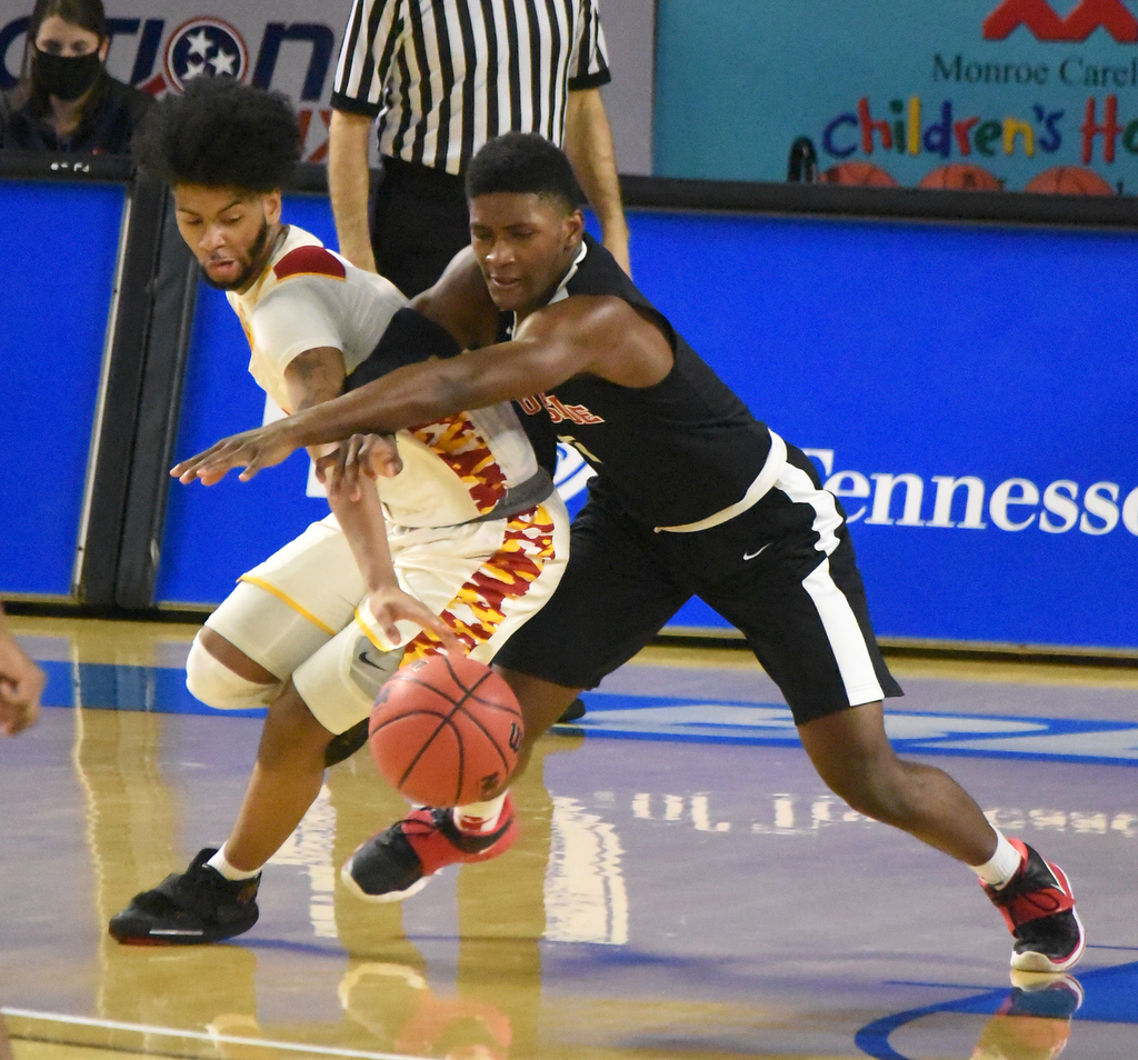 Staff Photo by Matt Hamilton / Howard's (1) Mark Greer battles for the ball with Jackson South Side's (2) Jailen Anderson at the Murphy Center in Murfreesboro on Thursday, March 18, 2021.