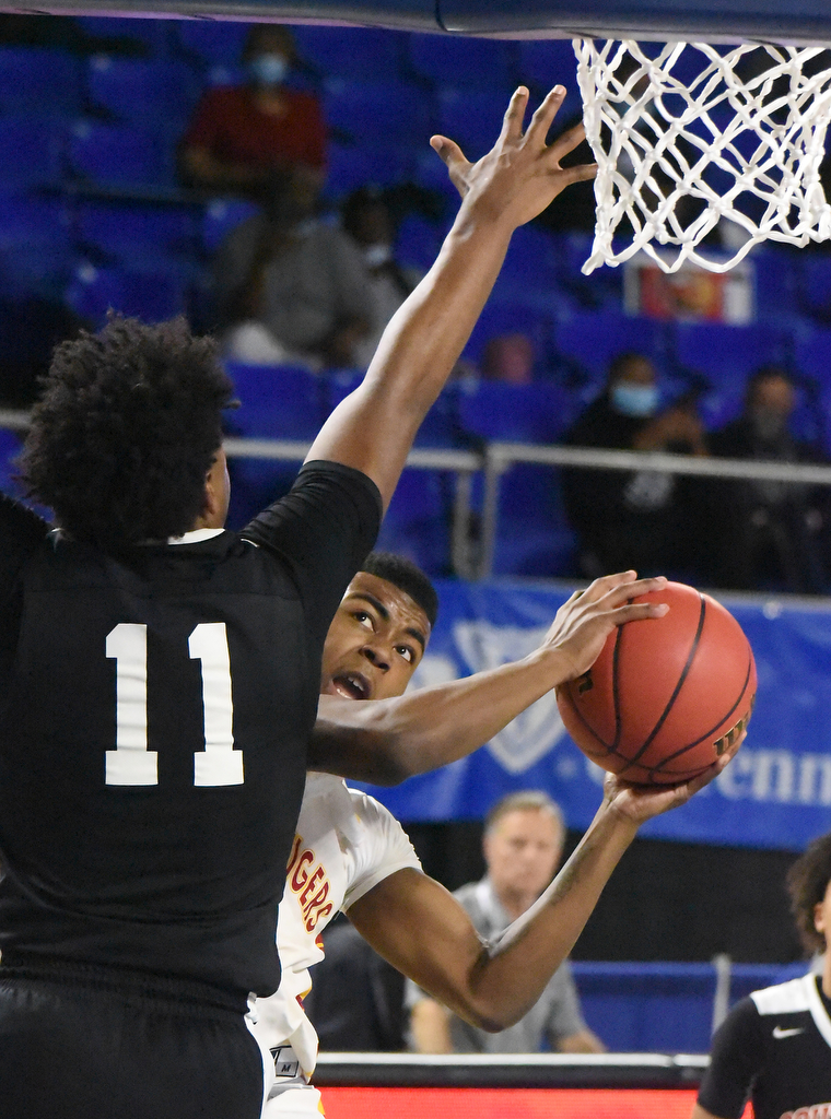 Staff Photo by Matt Hamilton / Howard's (3) Jacobi Dixon puts up a shot as Jackson South Side's (11) Brandon Maclin defends at the Murphy Center in Murfreesboro on Thursday, March 18, 2021.