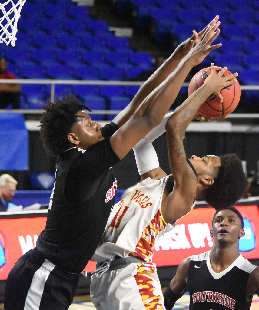 Staff Photo by Matt Hamilton / Howard's (11) Xavier Fisher puts up a shot as Jackson South Side's (11) Brandon Maclin defends at the Murphy Center in Murfreesboro on Thursday, March 18, 2021.