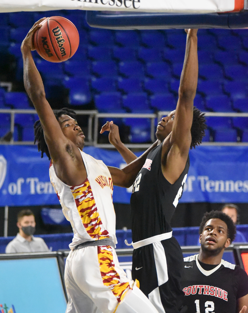 Staff Photo by Matt Hamilton / Howard's (5) Kerrick Thorne attempts a slam as Jackson South Side's (22) Cam'ron Anderson defends at the Murphy Center in Murfreesboro on Thursday, March 18, 2021.