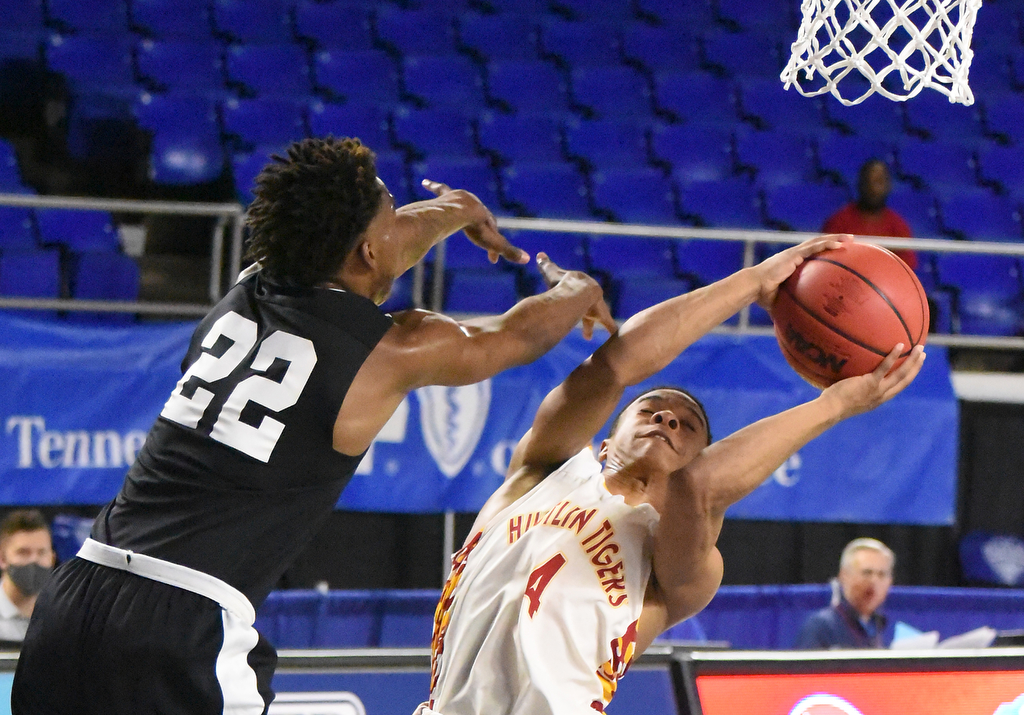 Staff Photo by Matt Hamilton / Howard's (4) Jadon Jenkins puts up a shot as Jackson South Side's (22) Cam'ron Anderson defends at the Murphy Center in Murfreesboro on Thursday, March 18, 2021.