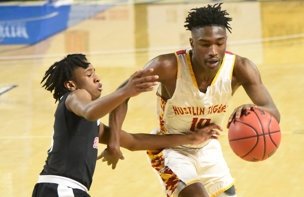 Staff Photo by Matt Hamilton / Howard (10) Demetrius Bowens drives down the court as Jackson South Side (4) Bryson Baker defends at the Murphy Center in Murfreesboro on Thursday, March 18, 2021.