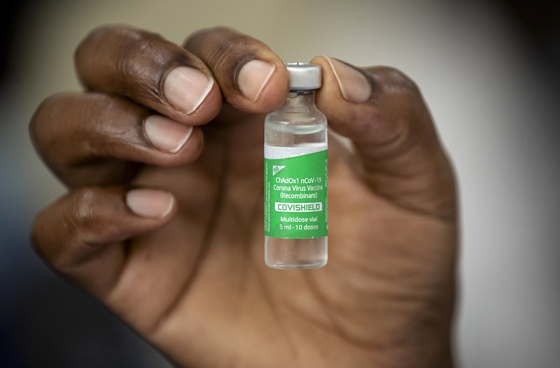 FILE - In this March 5, 2021, file photo, a nurse holds a vial of AstraZeneca COVID-19 vaccine provided through the global COVAX initiative, at Kenyatta National Hospital in Nairobi, Kenya. The suspension of the AstraZeneca vaccine in several European countries could fuel skepticism about the shot far beyond their shores, potentially threatening the rollout of a vaccine that is key to the global strategy to stamp out the coronavirus pandemic, especially in developing nations. (AP Photo/Ben Curtis, File)