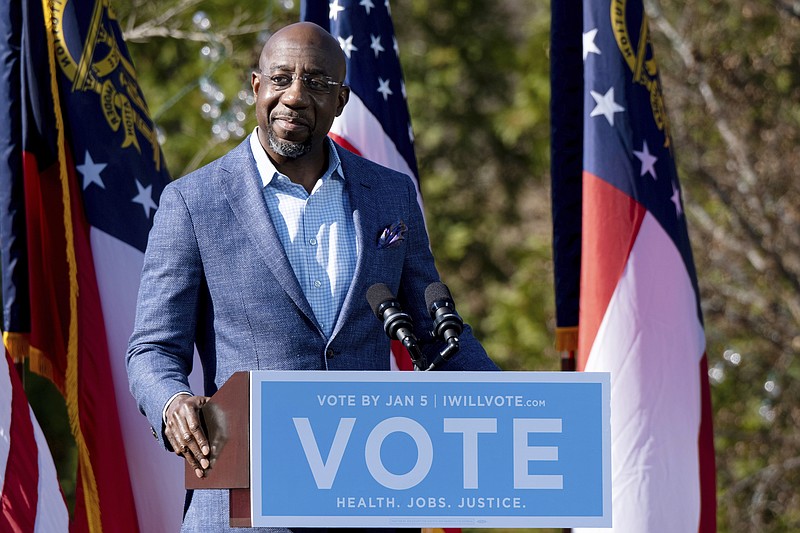 AP file photo by Ben Gray / Then-Democratic U.S. Senate challenger the Rev. Raphael Warnock speaks during a December 2020 rally in Columbus, Georgia. with Vice President-Elect Kamala Harris and fellow Democratic U.S. Senate challenger Jon Ossoff. Warnock and Ossoff are not U.S. senators.