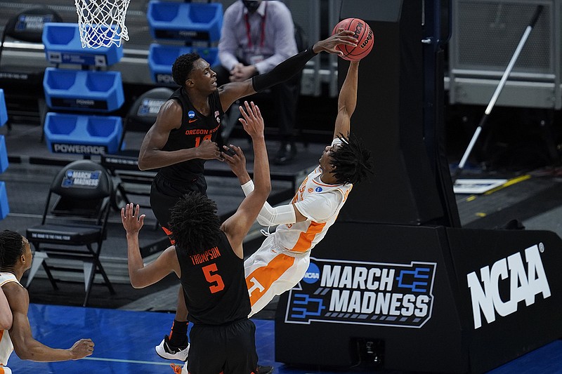 AP photo by Paul Sancya / Oregon State forward Warith Alatishe, left, blocks a shot by Tennessee guard Keon Johnson during the first half of an NCAA tournament first-round matchup Friday in Indianapolis.