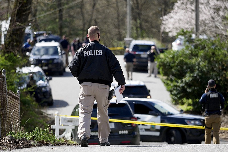 Staff photo by C.B. Schmelter / A police officer walks towards a crime scene along Premium Drive on Friday, March 19, 2021 in Chattanooga, Tenn.