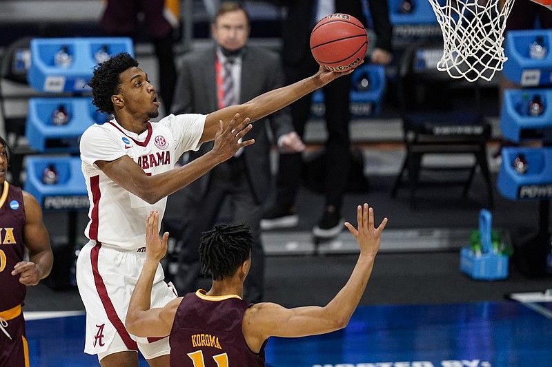 AP photo by Michael Conroy / Alabama forward Herbert Jones shoots over Iona's Dwayne Koroma during an NCAA tournament first-round game Saturday at Hinkle Fieldhouse in Indianapolis. Jones scored 20 points as the second-seeded Crimson Tide won 68-55 after leading by a point a halftime.