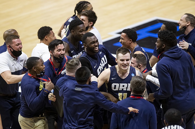 AP photo by Robert Franklin / Oral Roberts players and coaches celebrate after beating Ohio State 75-72 in the first round of the NCAA men's basketball tournament Friday in West Lafayette, Ind.
