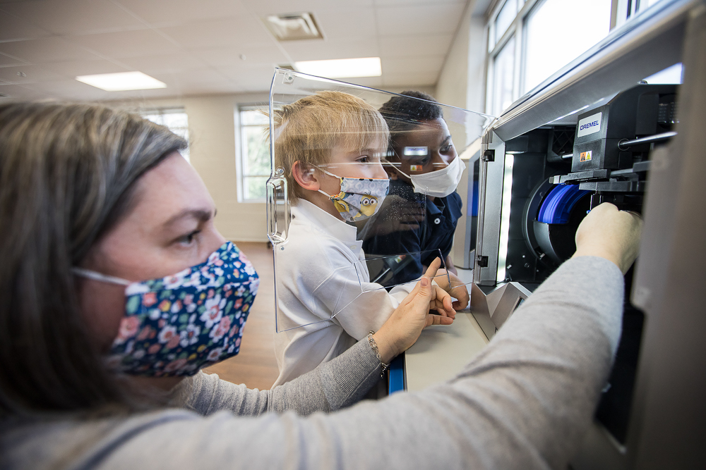 Staff photo by Troy Stolt / Hamilton County School District Innovation Coach Jessica Holloway shows Kaemon Baecker, 6, and Jeremy Young, 6, Brown Academy's new 3D printers on Monday, March 22, 2021 in Chattanooga, Tenn. Brown Academy is one of seven schools who will be given funding to create an eLab for their students, after a recent donation to the Chattanooga Public Education Fund.