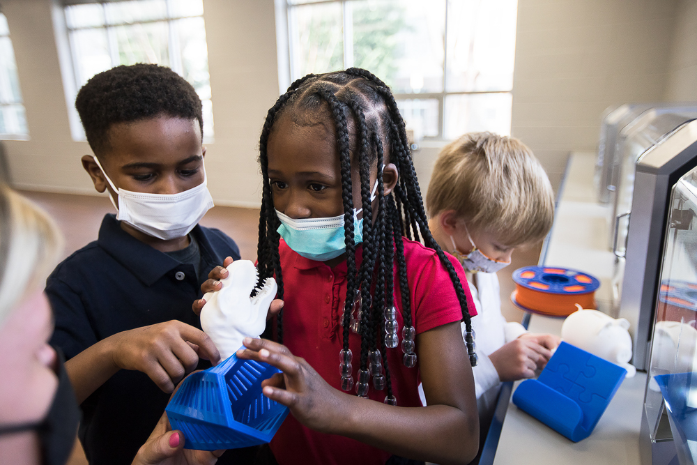 Staff photo by Troy Stolt / Nikki Russell, an innovations specialist at Brown Academy, shows Jeremy Young, 6, Kali McReynolds, 6, and Kaemon Baecker, 6, a 3D-printed object on Monday, March 22, 2021 in Chattanooga, Tenn. Brown Academy is one of seven schools who will be given funding to create an eLab for their students, after a recent donation to the Chattanooga Public Education Fund.
