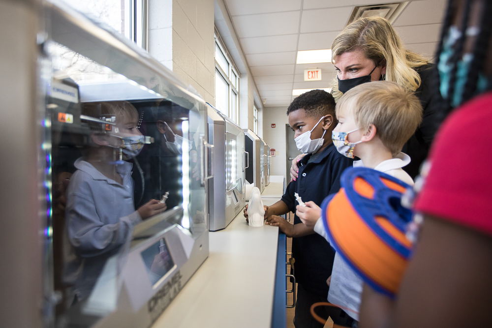 Staff photo by Troy Stolt / Jeremy Young, 6, and Kaemon Baecker, 6, are introduced to the new 3D printers at Brown Academy by Nikki Russell, the school's innovation specialist, on Monday, March 22, 2021 in Chattanooga, Tenn. Brown Academy is one of seven schools who will be given funding to create an eLab for their students, after a recent donation to the Chattanooga Public Education Fund.