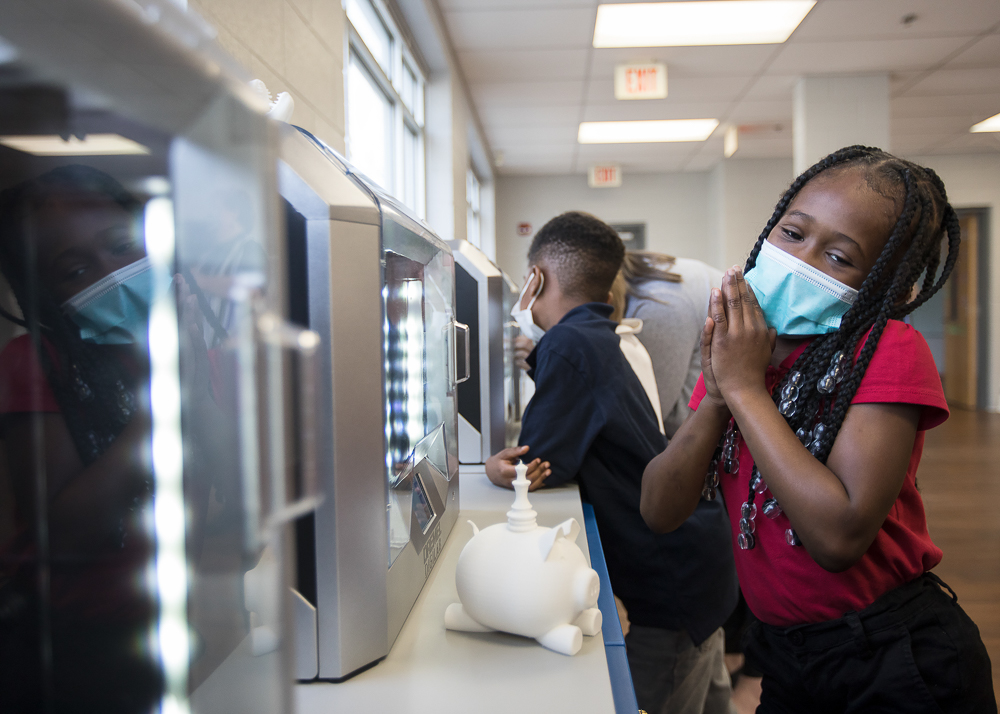 Staff photo by Troy Stolt / Kali McReynolds, 6, plays with the new 3D printers at Brown Academy on Monday, March 22, 2021 in Chattanooga, Tenn. Brown Academy is one of seven schools who will be given funding to create an eLab for their students, after a recent donation to the Chattanooga Public Education Fund.
